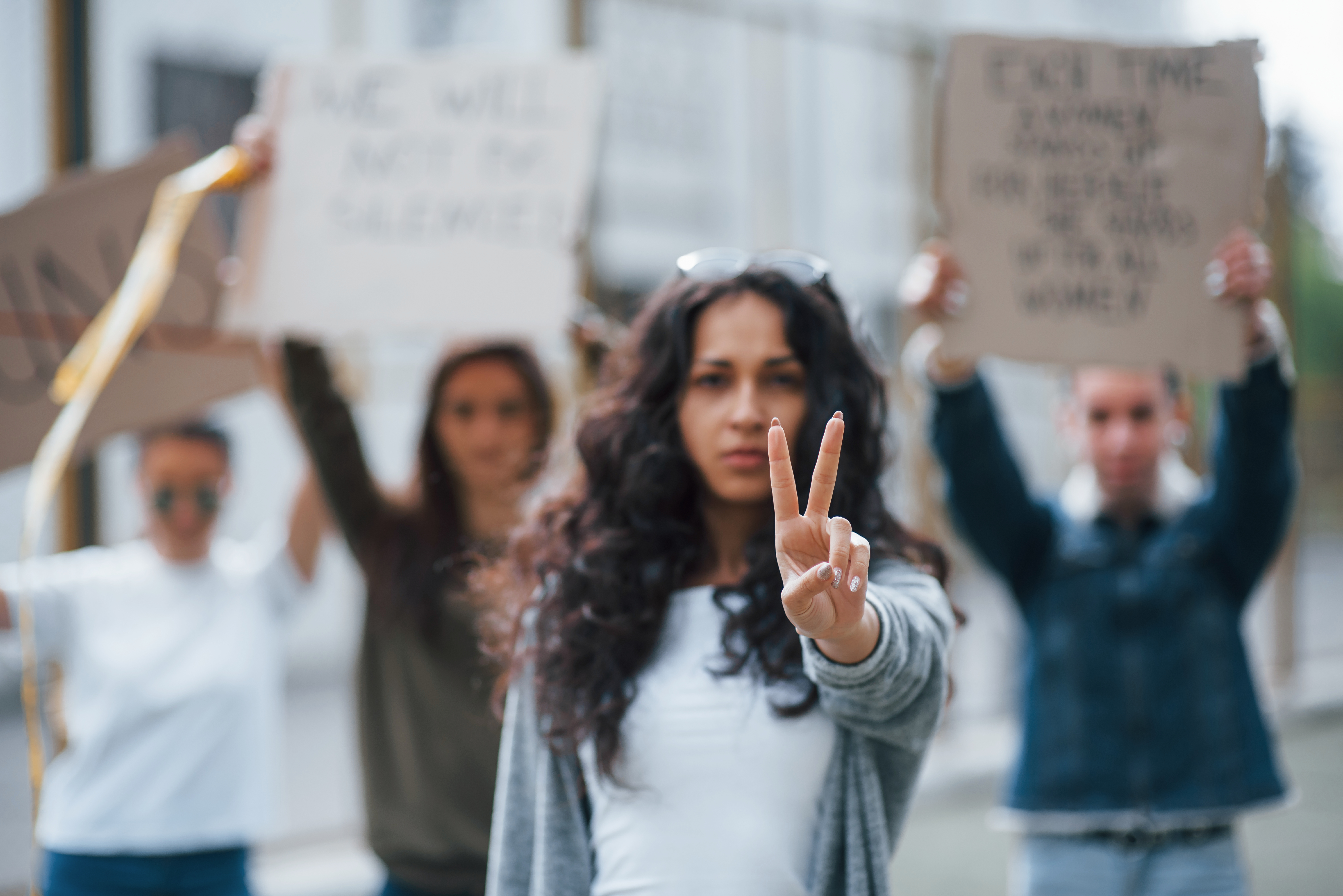 showing-gesture-by-two-fingers-group-of-feminist-women-have-protest-for-their-rights-outdoors.jpg