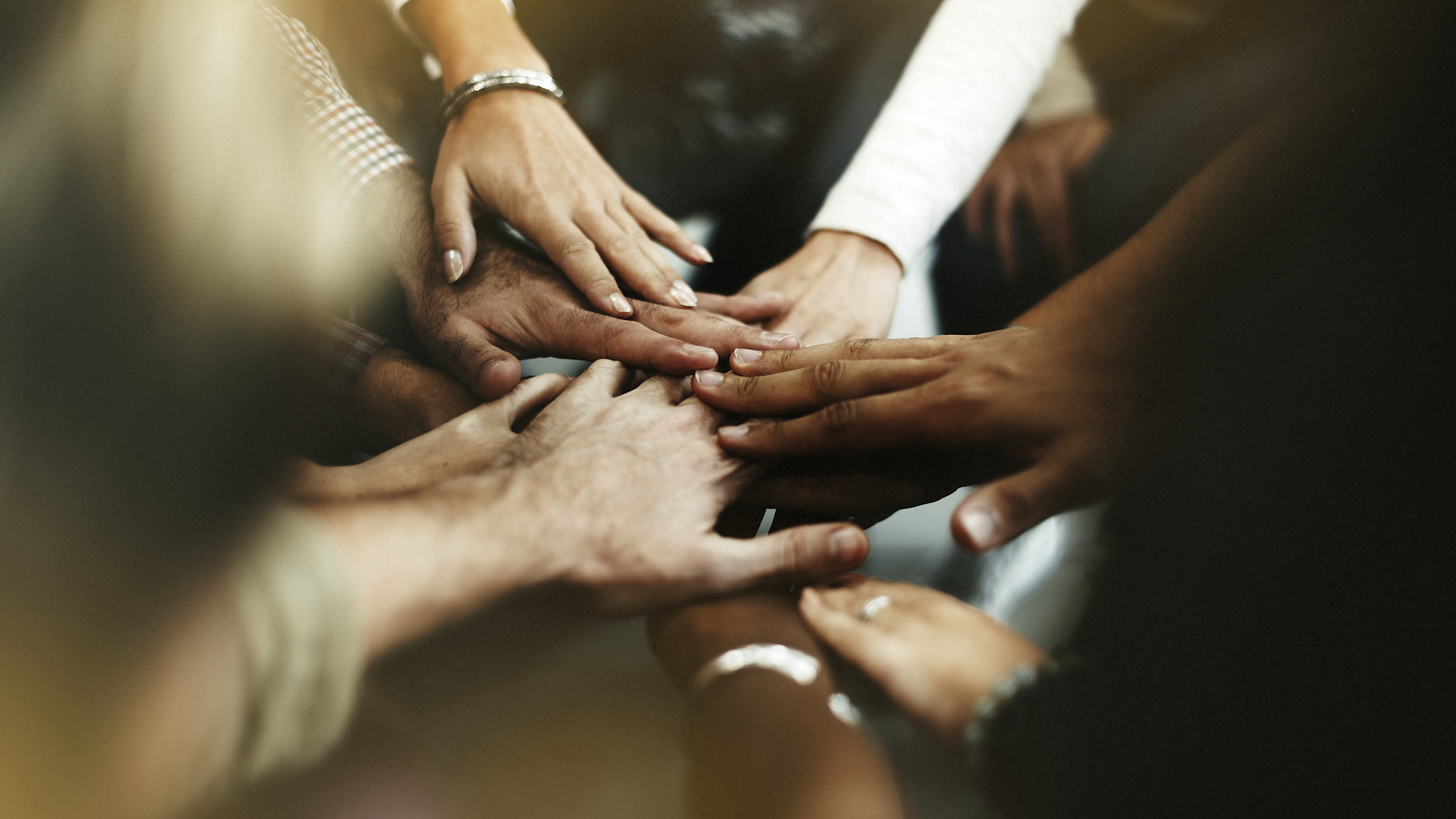 closeup-of-diverse-people-joining-their-hands.jpg